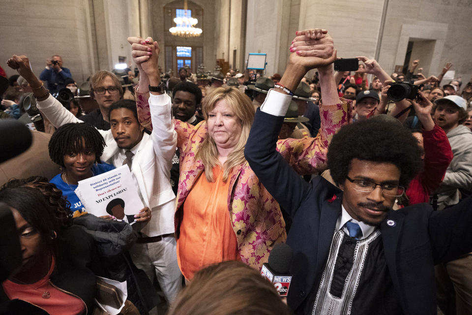 Former Rep. Justin Jones, D-Nashville, Rep. Gloria Johnson, D-Knoxville, and former Rep. Justin Pearson, D-Memphis, raises their hands outside the House chamber after Jones and Pearson were expelled from the legislature Thursday, April 6, 2023, in Nashville, Tenn. (George Walker IV / AP)