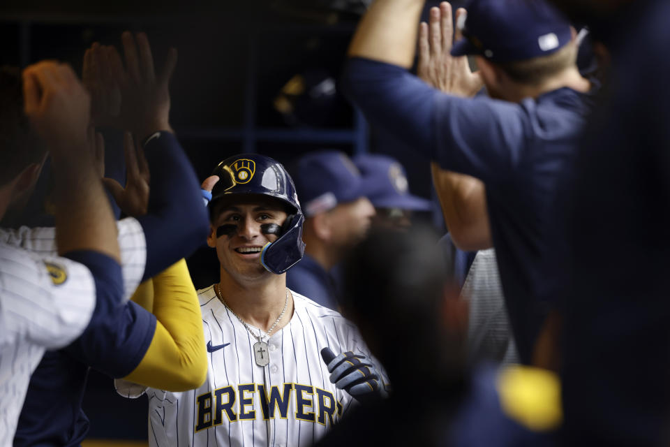 Milwaukee Brewers' Joey Ortiz(3) is congratulated in the dugout after hitting a three-run home run in the fifth inning of a baseball game against the Cincinnati Reds, Saturday, June 15, 2024, in Milwaukee. (AP Photo/Jeffrey Phelps)