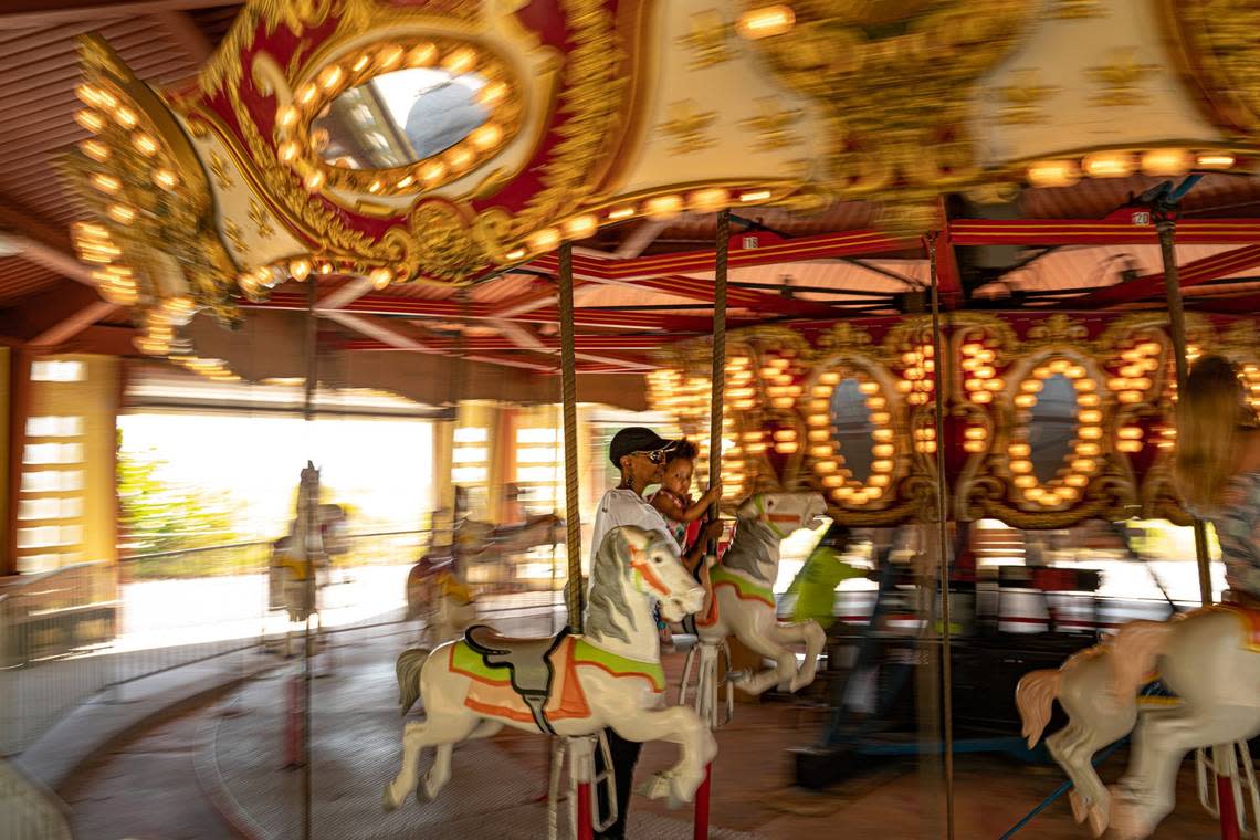 Peoople ride the carousel at Historic Virginia Key Beach Park on Key Biscayne, Florida on Saturday, November 12, 2022.