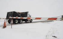 An Elbert County truck with sand passes the closure barrier on Colorado County Highway 86 just east of Kiowa, Colo.. The road was closed to Limon after a blizzard hit the eastern plains of the state. Jerilee Bennett/The Gazette via AP)