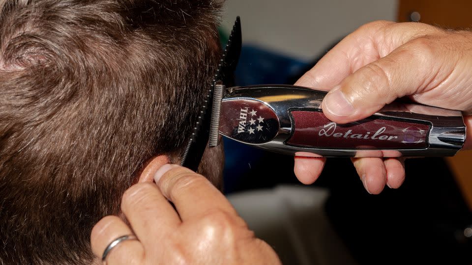 Julien Farel puts the finishing touches on tennis player Austin Krajicek's hair at Arthur Ashe Stadium in New York on August 30. - Will Lanzoni/CNN