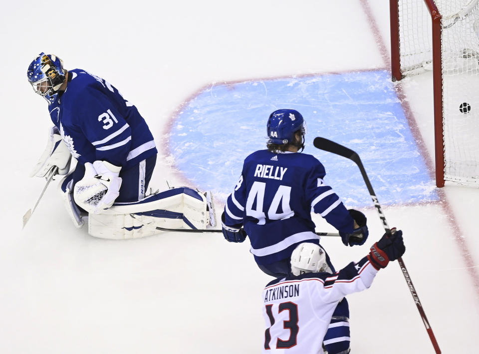 Columbus Blue Jackets right wing Cam Atkinson (13) scores past Toronto Maple Leafs goaltender Frederik Andersen (31) as Leafs defenceman Morgan Rielly (44) watches during the third period of an NHL hockey playoff game in Toronto, Sunday, Aug. 2, 2020. (Nathan Denette/The Canadian Press via AP)