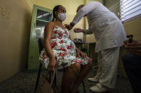 A nurse gives a pregnant woman a shot of the Cuban Abdala vaccine for COVID-19 at a clinic during the new coronavirus pandemic in Havana, Cuba, Thursday, Aug. 5, 2021. ≈