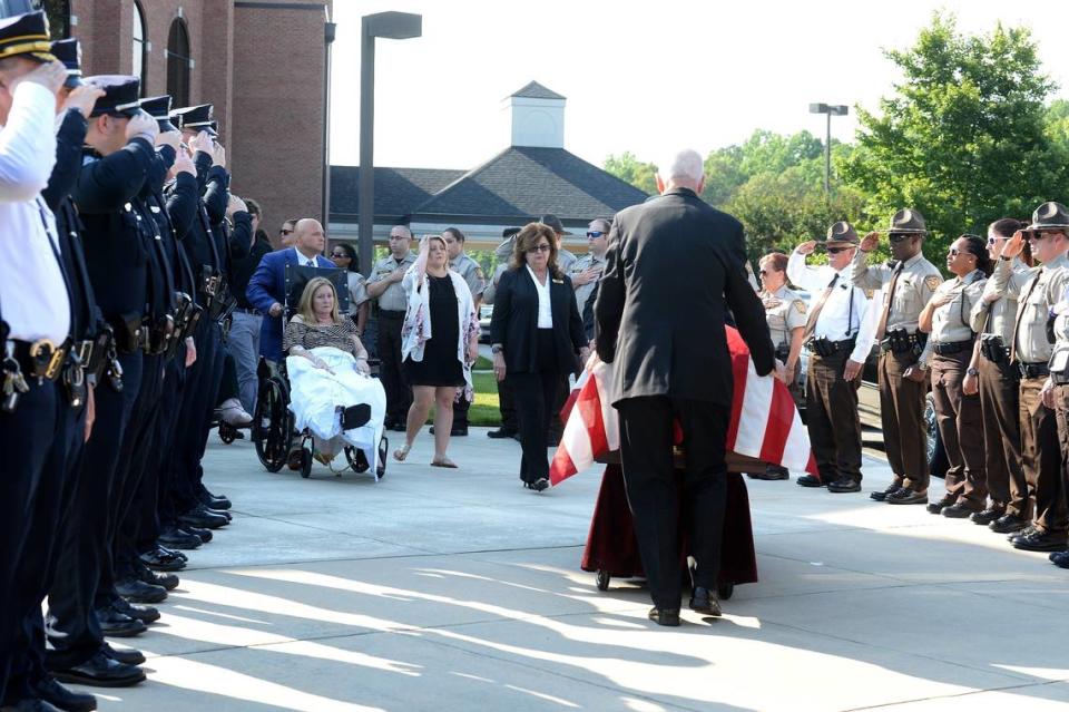 Katelyn Self’s casket is brought past an honor line at the end of Sunday’s service at the First Assembly of God Church in Gastonia. Her mother, Dianne Self, follows in a wheelchair, accompanied by Katelyn’s sister Taylor Potter.