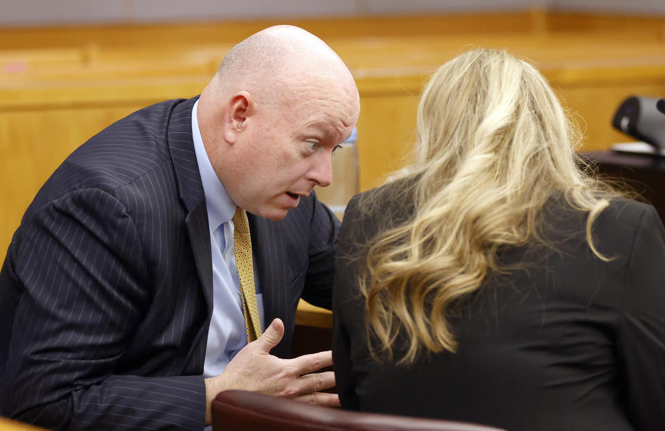 Prosecutor Glen Fitzmartin, left, confers with fellow assistant district attorney Jaclyn O'Connor as motions and language being sent to the jury were formed after one juror is hanging up the deliberations in the capital murder trial of Billy Chemirmir at the Frank Crowley Courts Building in Dallas, Friday, Nov. 19, 2021. He was joined by his defense attorney Mark Watson and private investigator Tonia Silva. Chemirmir, 48, faces life in prison without parole if convicted of capital murder for smothering Lu Thi Harris, 81, and stealing her jewelry. He is accused of killing at least 18 women in Dallas and Collin counties. (Tom Fox/The Dallas Morning News via AP, Pool)