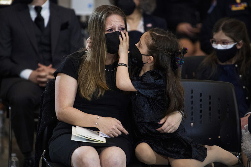 Abigail Evans, 7, and her mother Shannon Terranova, listen during a memorial service for the late U.S. Capitol Police officer William "Billy" Evans, as he lies in honor in the Rotunda at the U.S. Capitol, Tuesday, April 13, 2021 in Washington. (Tom Williams/Pool via AP)