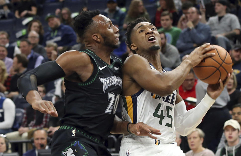 Utah Jazz's Donovan Mitchell, right, eyes the basket while Minnesota Timberwolves' Josh Okogie defends during the first half of an NBA basketball game Wednesday, Oct. 31, 2018, in Minneapolis. (AP Photo/Jim Mone)