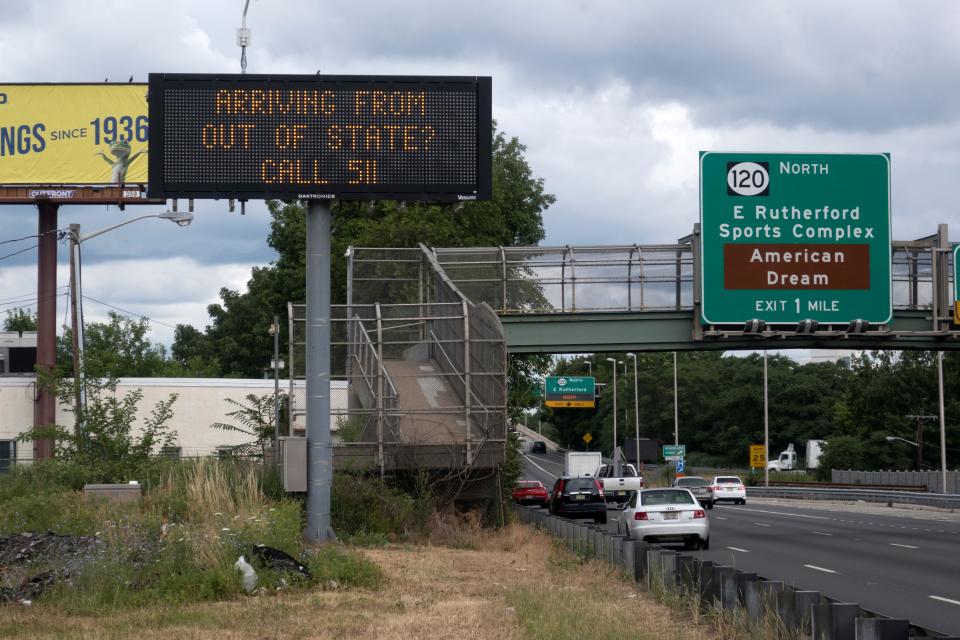 A sign advises out-of-state visitors to call and learn if they should self-quarantine for two weeks in Secaucus, New Jersey, Tuesday, June 30, 2020.