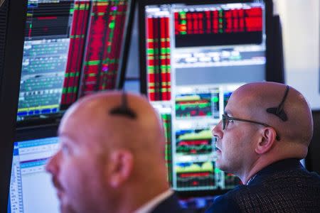 Traders work on the floor of the New York Stock Exchange shortly after the opening bell in New York, July 8, 2015. REUTERS/Lucas Jackson