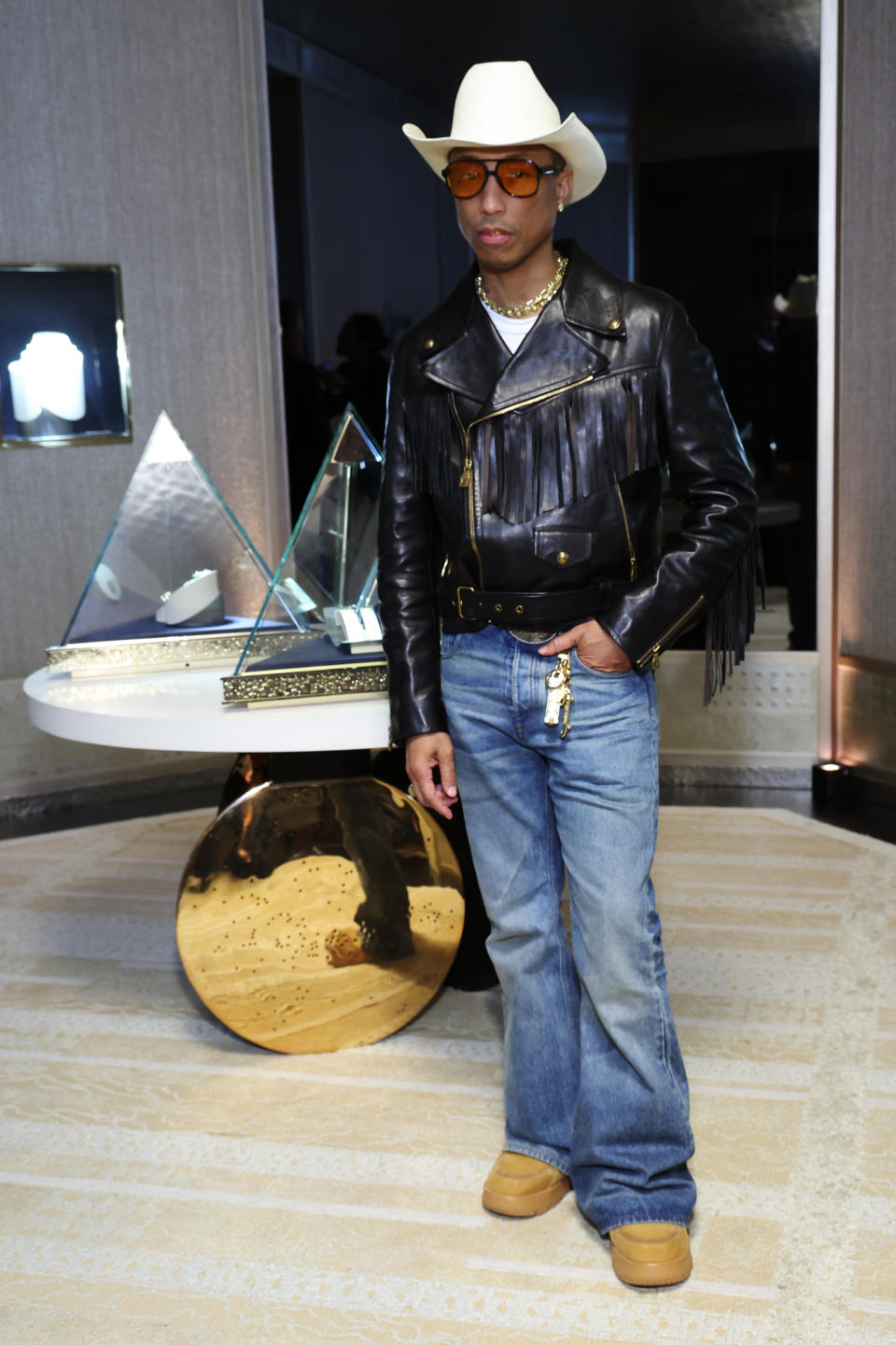 Pharrell Williams attends celebrates the debut of the Tiffany Titan in tan clog boots