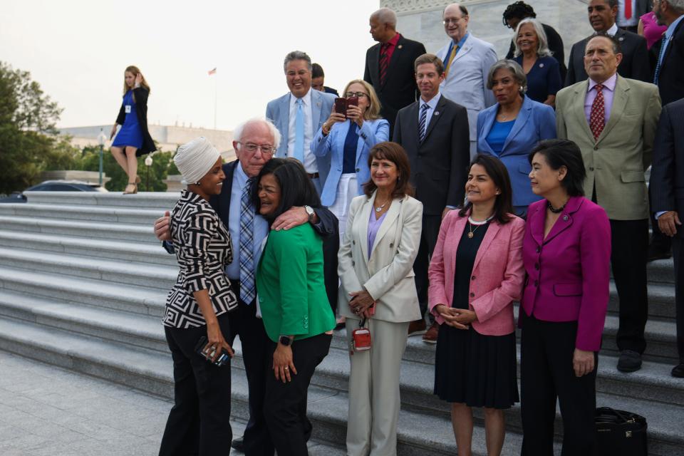 Sen. Bernie Sanders, I-Vt., center, greets Rep. Ilhan Omar D-Minn., left, and Rep. Pramila Jayapal, D-Wash., before a group photo with members of the Congressional Progressive Caucus in front of the U.S. Capitol Building on July 19, 2021, in Washington, D.C.