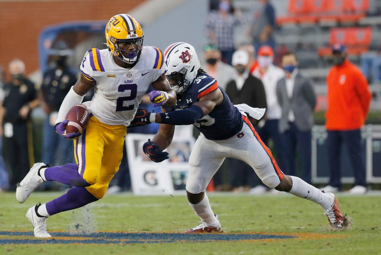 Oct 31, 2020; Auburn, Alabama, USA;  LSU Tigers tight end Arik Gilbert (2) is tackled by Auburn Tigers linebacker Cam Riley (35) during the fourth quarter at Jordan-Hare Stadium. Mandatory Credit: John Reed-USA TODAY Sports