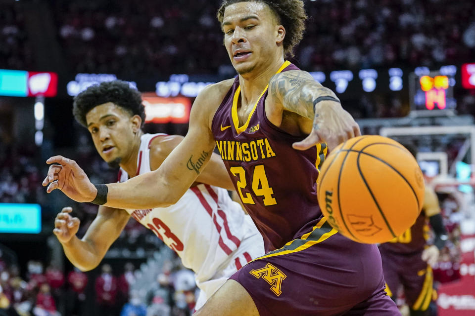 Minnesota's Sean Sutherlin (24) looses control of the ball against Chucky Hepburn during the first half of an NCAA college basketball game Sunday, Jan. 30, 2022, in Madison, Wis. (AP Photo/Andy Manis)