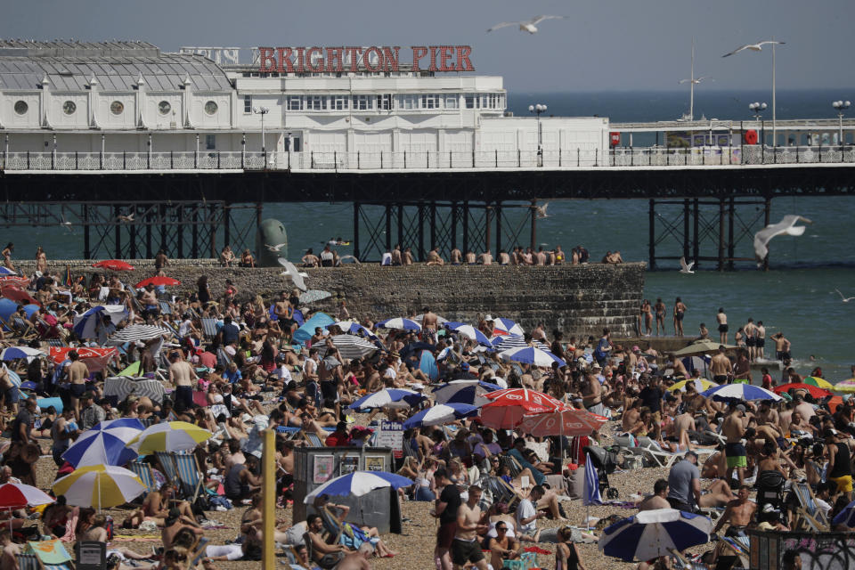 FILE - In this file photo dated Wednesday, June 24, 2020, large numbers of people relax on the beach in Brighton, England. The British government insists that science is guiding its decisions as the country navigates its way through the coronavirus pandemic. But a self-appointed group of independent experts led by a former government chief adviser says it sees little evidence-based about Britain’s response. Unlike other countries, the scientific opposition to Britain’s approach is remarkably organized. The independent group sits almost in parallel to the government’s own scientists, assesses the same outbreak indicators and has put out detailed reports on issues such contact tracing, reopening schools and pubs, and relaxing social distancing. (AP Photo/Matt Dunham, File)