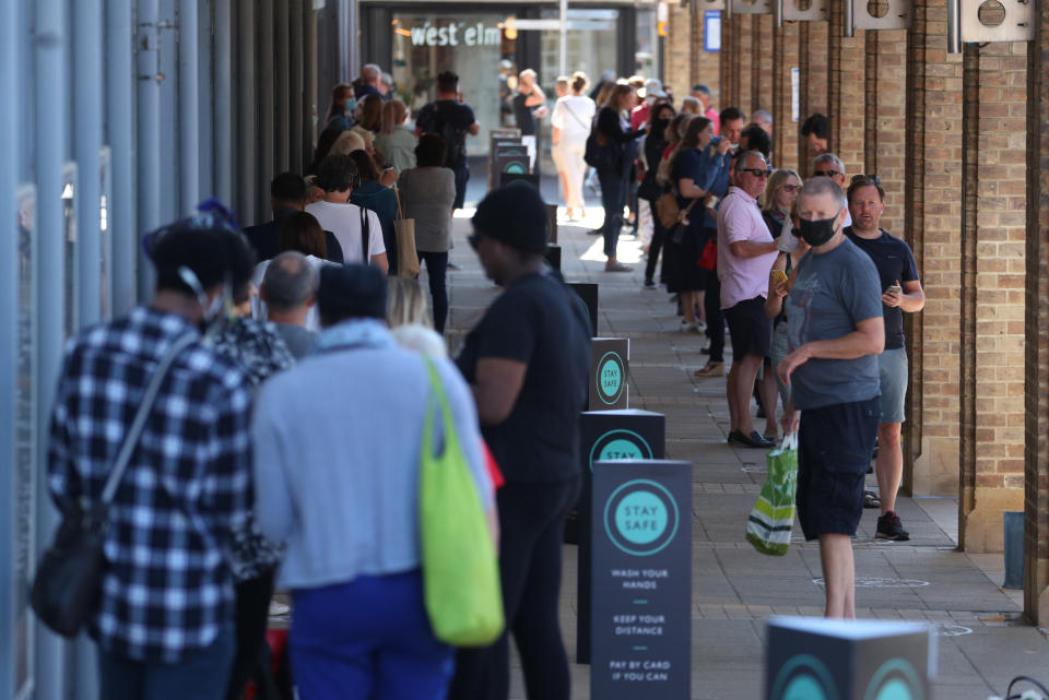 Shoppers in line outside John Lewis in Kingston as non-essential shops in England open their doors to customers for the first time since coronavirus lockdown restrictions were imposed in March. (Photo by Steve Parsons/PA Images via Getty Images)