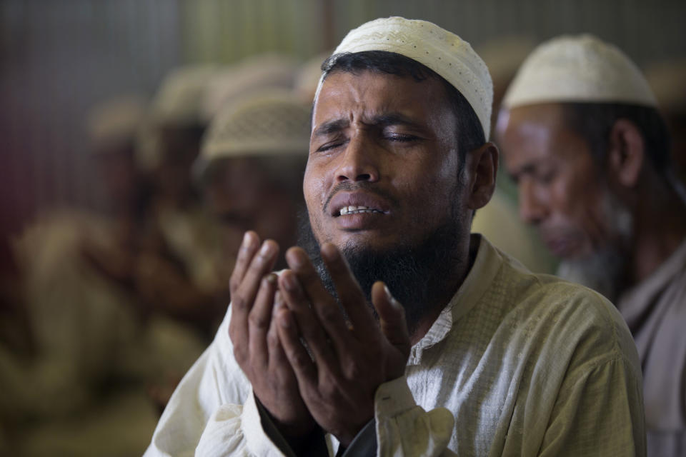 A Rohingya refugee cries as he prays with others inside a mosque as government officials postponed plans to begin repatriating residents to Myanmar inside Unchiprang refugee camp near Cox's Bazar, in Bangladesh, Friday, Nov. 16, 2018. Normal life returned to a Rohingya Muslim refugee camp in Bangladesh on Friday a day after government officials postponed plans to begin repatriating residents to Myanmar when no one volunteered to go. (AP Photo/Dar Yasin)