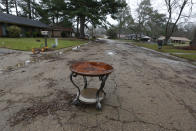 The strength of the Pearl River current pulled an end table from a residence in northeast Jackson, Miss., and deposited it in the road, Wednesday, Feb. 19, 2020. Depending on how much the flooding has receded, authorities in various flooded communities, allowed residents to return to their homes to begin cleanup. (AP Photo/Rogelio V. Solis)