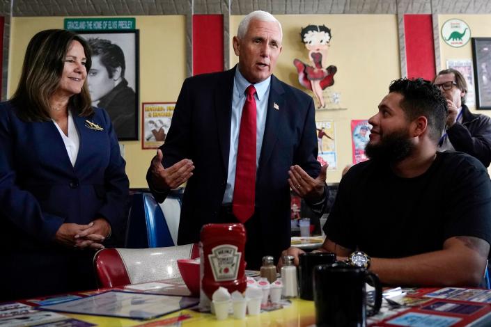 Former Vice President Mike Pence, Republican presidential candidate, and his wife Karen, left, chat with a customer during a campaign stop at a restaurant, June 9, 2023, in Derry, NH