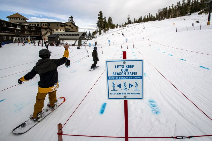 MAMMOTH LAKES, CA - NOVEMBER 20, 2020: Blue dye in the snow marks "social distancing" in a lift line at Mammoth Mountain on November 20, 2020 in Mammoth Lakes, California. Because of COVID-19, Mammoth Mountain is not selling walk-up lift tickets this season. Everyone must make a reservation, except season ticket holders, those with the Ikon Pass.(Gina Ferazzi / Los Angeles Times)