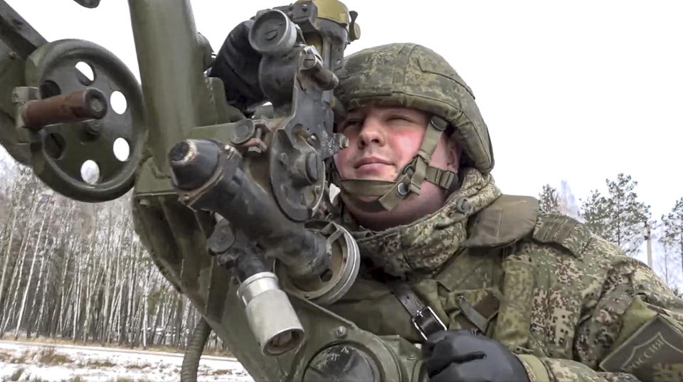 In this photo taken from video and released by the Russian Defense Ministry Press Service on Friday, Feb. 4, 2022, a soldier takes part in the Belarusian and Russian joint military drills at Brestsky firing range, Belarus. Russian and Belarus troops held joint combat training at firing ranges in Belarus. The drills involved motorized rifle, artillery and anti-tank missile units, as well tanks and armored personnel carriers crews. (Russian Defense Ministry Press Service via AP)