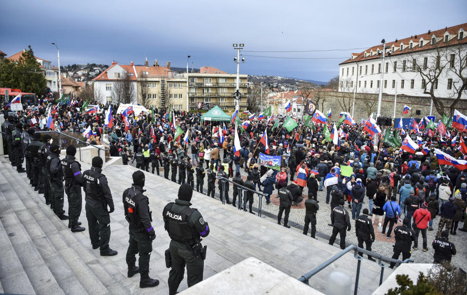 Thousands of Slovaks rally to protest a defense military treaty between this NATO member and the United States, in Bratislava, Slovakia, Tuesday, Feb. 8, 2022. Waving national flags, the protesters gathered in front of the Parliament that was debating the Defense Cooperation Agreement. (Pavol Zachar/TASR via AP)