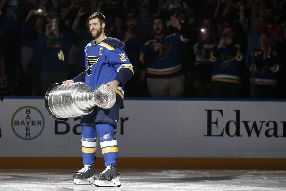 FILE - In this Oct. 2, 2019, file photo, St. Louis Blues captain Alex Pietrangelo lifts the Stanley Cup during a ceremony honoring the Blues championship victory before the start of an NHL hockey game against the Washington Capitals in St. Louis. The past few weeks have seen several recent Stanley Cup winners get rid of members of their championship core. The Chicago Blackhawks moved on from Corey Crawford, the Washington Capitals did the same with Braden Holtby, the Pittsburgh Penguins traded fellow goalie Matt Murray and forward Patric Hornqvist and the St. Louis Blues signing Torey Krug means captain Alex Pietrangelo will sign elsewhere. (AP Photo/Jeff Roberson, File)