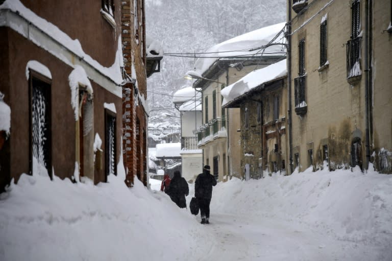 People walk in street of Aringo near Montereale, after a 5.7-magnitude earthquake struck the region, on January 18, 2017