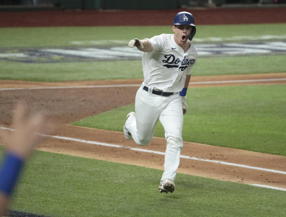 Will Smith points to the dugout on his way to first after hitting a two-run single.