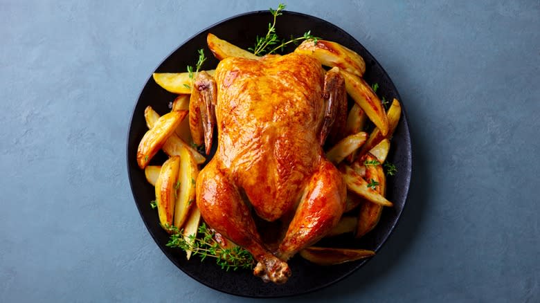 Whole chicken on black plate