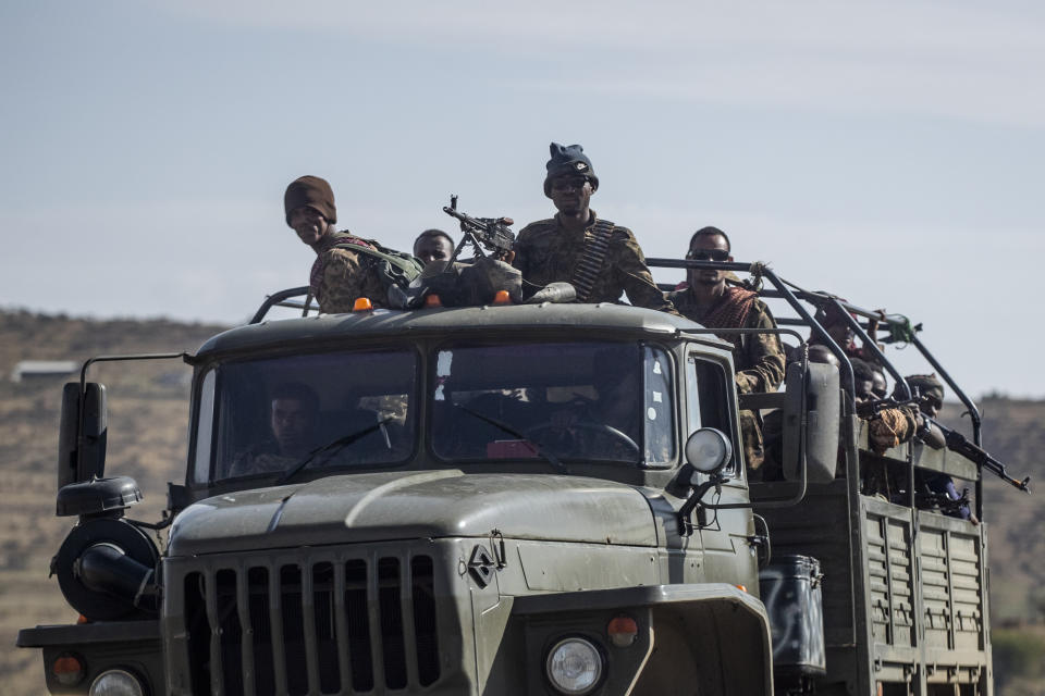Ethiopian government soldiers ride in the back of a truck on a road near Agula, in the Tigray region of northern Ethiopia, on Saturday, May 8, 2021. As the Tigray People’s Liberation Front and the government forces fight, civilians, and especially children, are suffering heavily. (AP Photo/Ben Curtis)