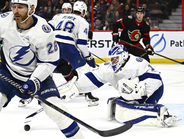 Tampa Bay Lightning goaltender Brian Elliott reaches out with his stick to grab the puck for a save against the Ottawa Senators during the second period of an NHL hockey game in Ottawa, Ontario, Thursday, March 23, 2023. (Justin Tang/The Canadian Press via AP)