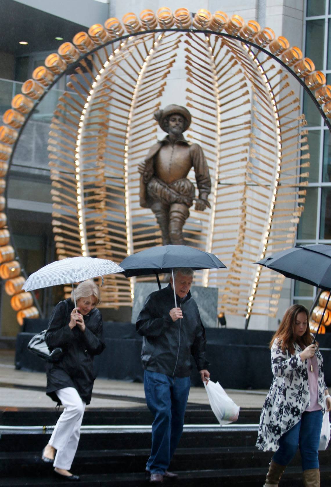 From left, Patricia Oldfield and husband David Oldfield, both visiting from England and family friend Lauren Jones of Raleigh had to put up their umbrellas as they left the Raleigh Convention Center Friday afternoon, October 2, 2015 during the 2015 Wide Open Bluegrass Festival. It was held indoors due to Hurricane Joaquin.