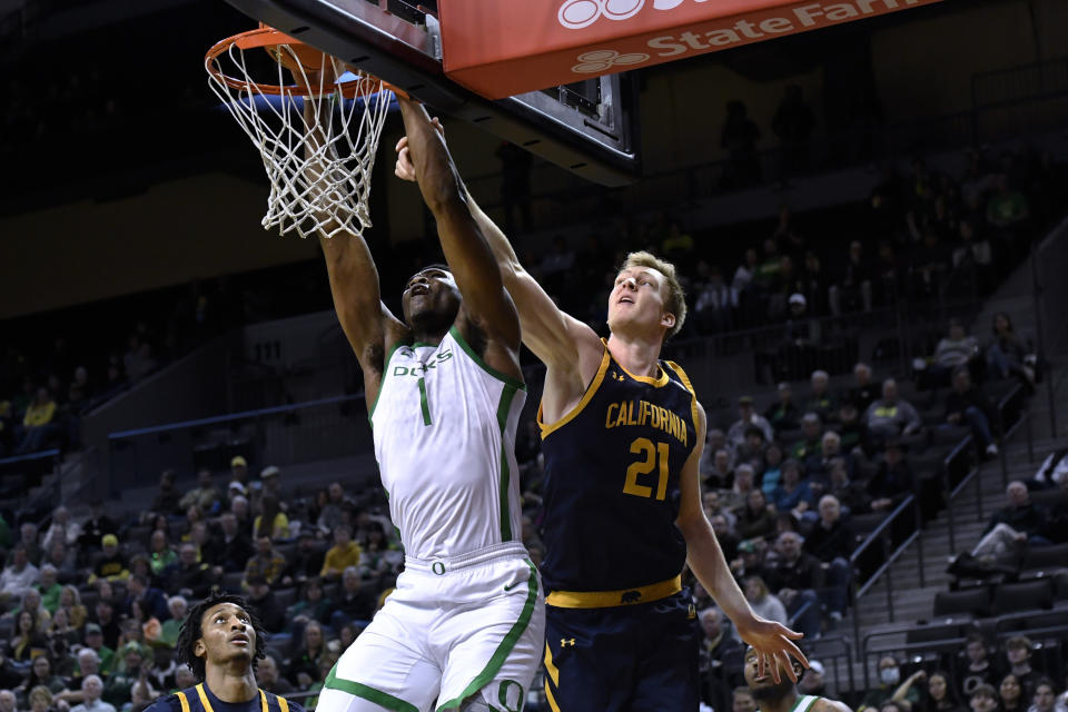 Oregon center N'Faly Dante (1) dunks against California forward Lars Thiemann (21) during the first half of an NCAA college basketball game Thursday, March 2, 2023, in Eugene, Ore. (AP Photo/Andy Nelson)
