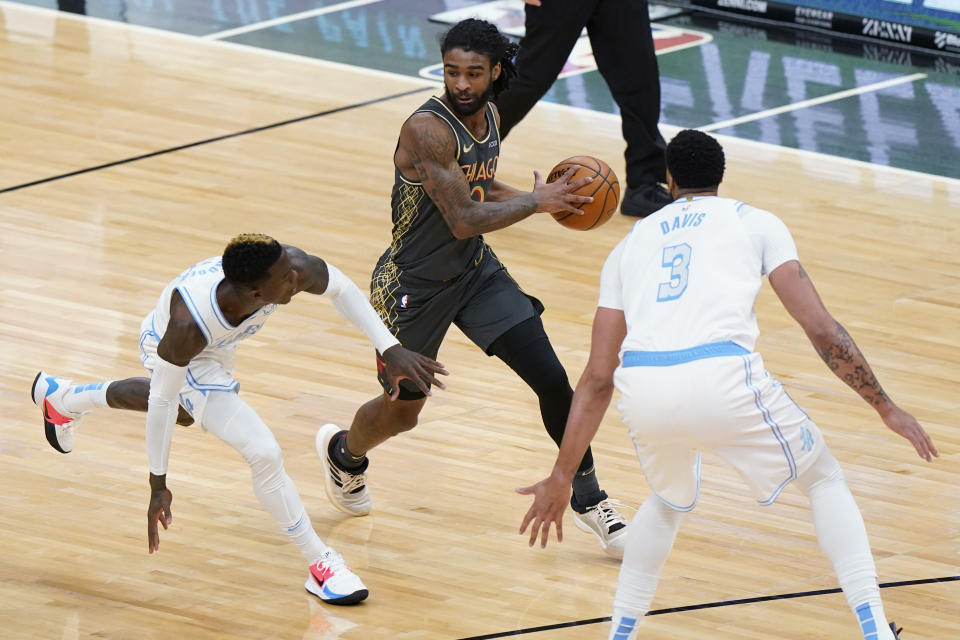 Chicago Bulls guard Coby White, center, looks to pass the ball as Los Angeles Lakers guard Dennis Schroeder, left, and forward Anthony Davis defend during the first half of an NBA basketball game in Chicago, Saturday, Jan. 23, 2021. (AP Photo/Nam Y. Huh)