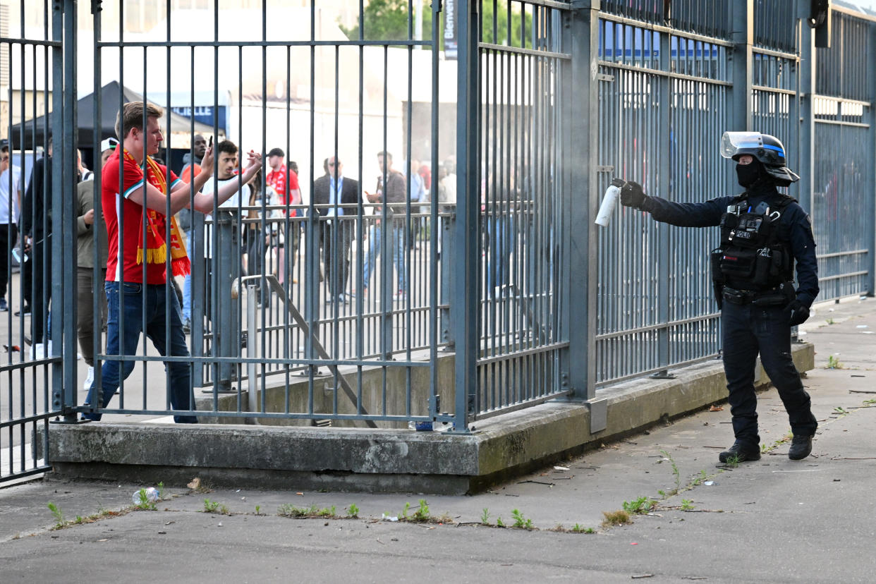 Police spray tear gas at Liverpool fans outside Stade de France prior to the UEFA Champions League final in Paris.