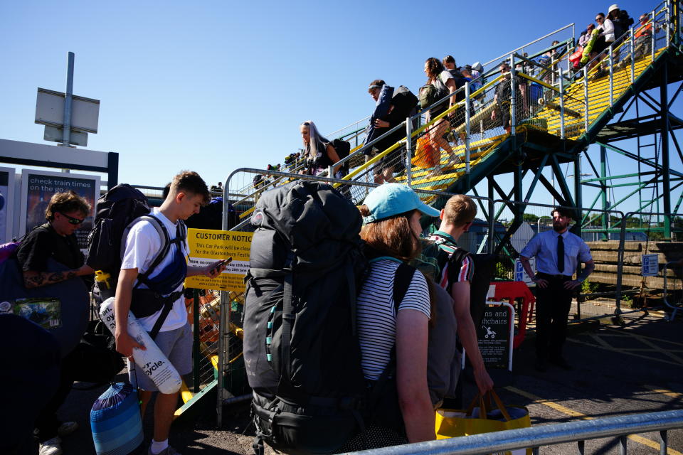 People arrive at Castle Cary train station during the Glastonbury Festival at Worthy Farm in Somerset. Picture date: Wednesday June 22, 2022.