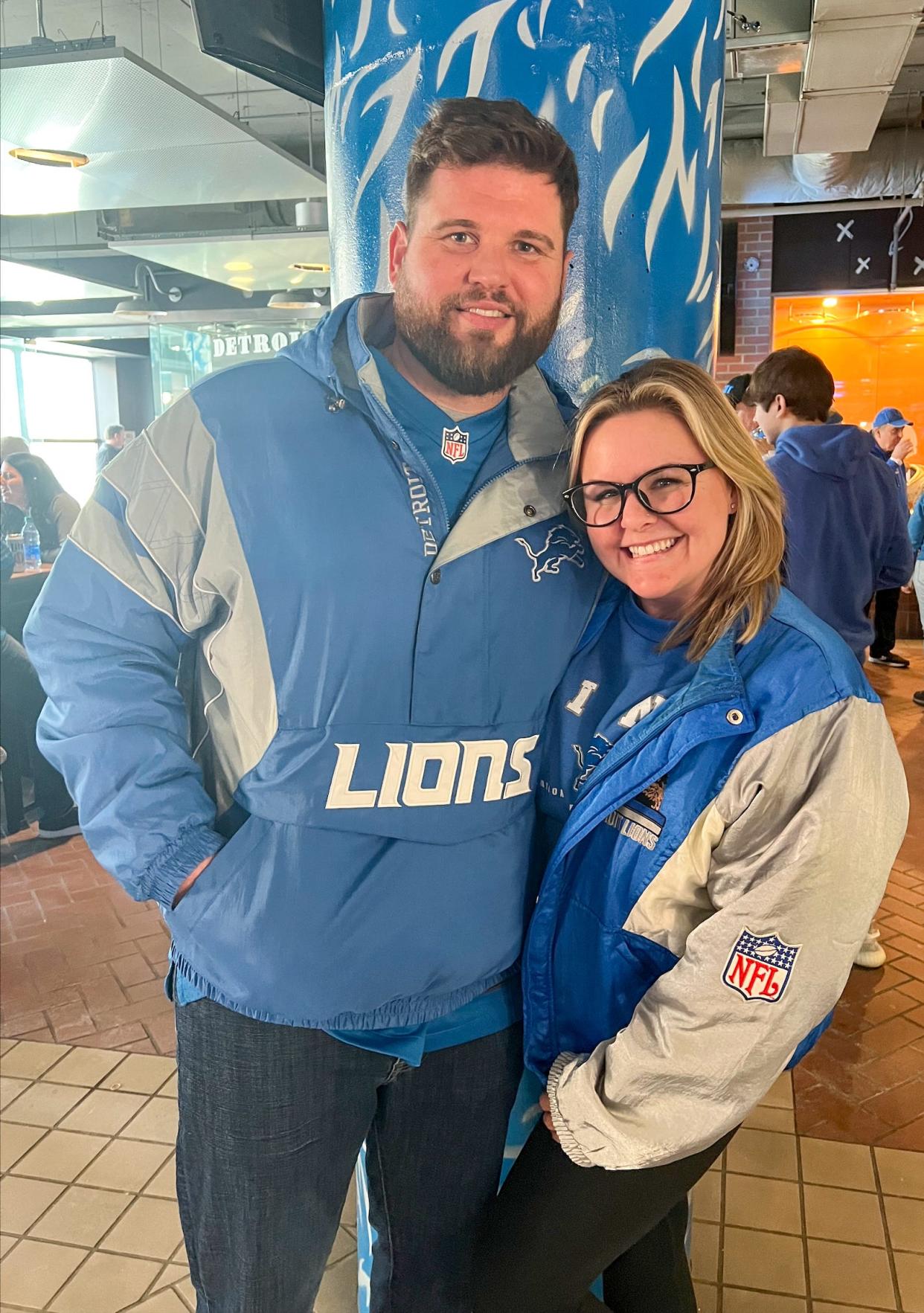 Ron and Randi Trombetti, of Macomb, pose for a photo ahead of the Detroit Lions vs. Tampa Bay Buccaneers game on Sunday, Jan. 21, 2024. Randi Trombetti was wearing a jacket which belonged to her grandfather, also a Lions fan.