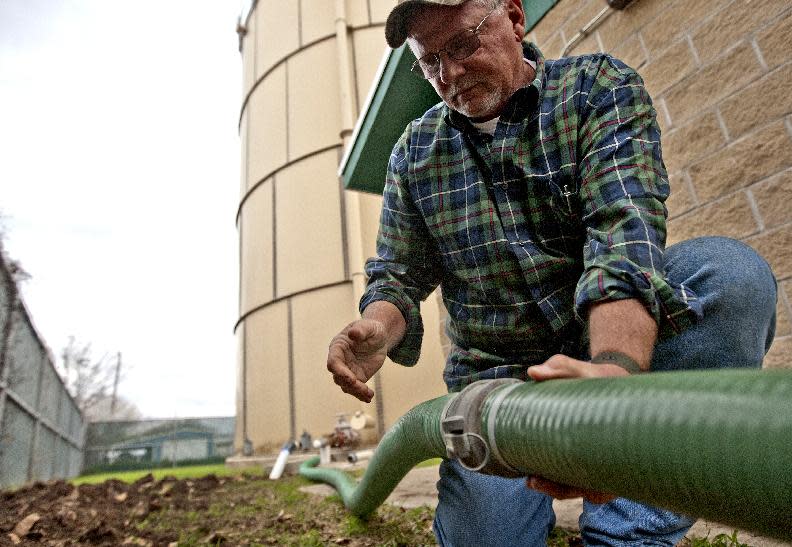 FILE - In this Jan. 30, 2012 file photo, Mike Stone of Lower Colorado River Authority prepares a water transfer to well on in Spicewood, Texas. Two tanker trucks for the first time delivered thousands of gallons of water to the Texas town that came precariously close to becoming the state's first community to run out of water during a historic drought. From Dallas to far-flung ranches and rice farms, Texans and officials are trying to capitalize on heightened drought awareness by adopting conservation plans that will ease the next crisis. (AP Photo/Austin American-Statesman, Ricardo B. Brazziell, File ) MAGS OUT; TV OUT; INTERNET OUT; AP MEMBERS ONLY