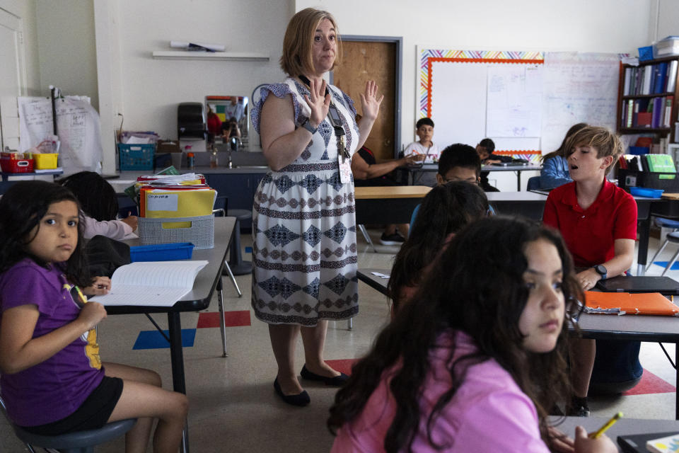 Fifth grade teacher Jana Lamontagne, center, teaches a math lesson during class at Mount Vernon Community School, in Alexandria, Va., Wednesday, May 1, 2024. (AP Photo/Jacquelyn Martin)