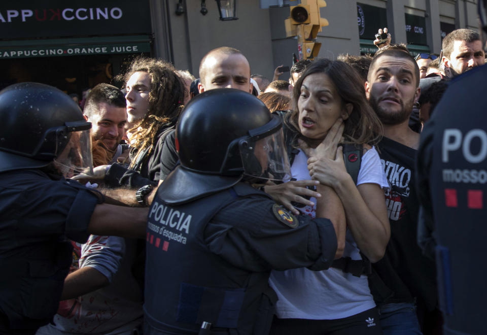 Catalan police officers clash with pro independence demonstrators on their way to meet demonstrations by members and supporters of National Police and Guardia Civil in Barcelona on Saturday, Sept. 29, 2018. (AP Photo/Emilio Morenatti)
