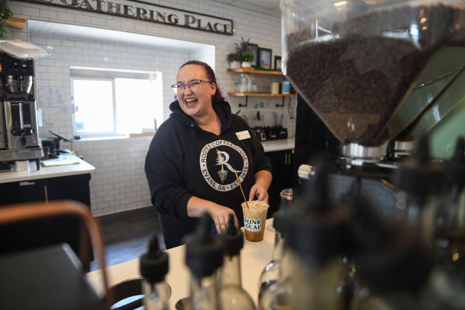 Manager Cassidy Eckles makes coffee at Rooted Coffeehouse in Evans, Ga., on Wednesday, Sept. 13, 2023.