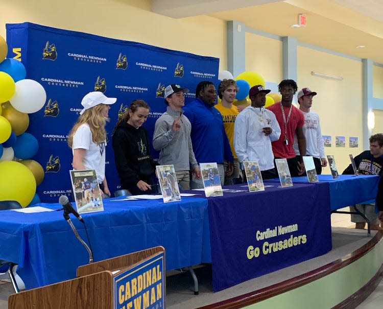 College-bound Cardinal Newman recruits pose together for a picture on national signing day.