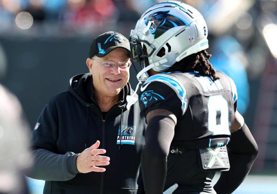 Carolina Panthers owner David Tepper, left, speaks with cornerback Jaycee Horn prior to the team’s game against the Tampa Bay Buccaneers at Bank of America Stadium in Charlotte on Jan. 7, 2024.