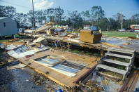 <p>Hurricane Andrew left one trailer home in complete ruins and surrounding homes untouched in Jeanerette, LA (Visions of America/UIG via Getty Images) </p>