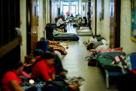 People are seen inside a shelter run by Red Cross before Hurricane Florence comes ashore in Grantsboro, North Carolina, U.S., September 13, 2018. REUTERS/Eduardo Munoz