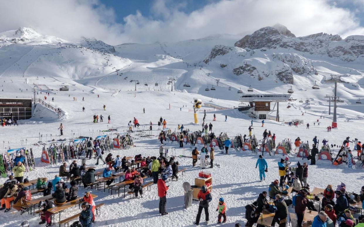 Skiers take a break in the sun at the Ischgl ski resort in Ischgl, Austria - Andrei Pungovschi/Bloomberg