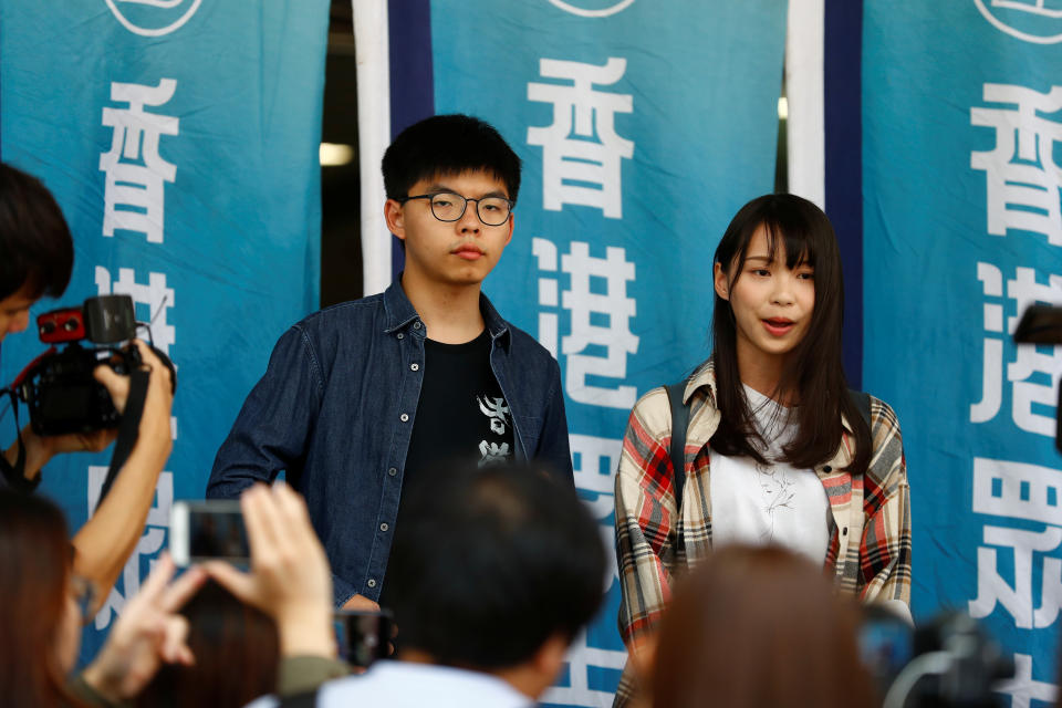 Hong Kong pro-democracy activists Joshua Wong and Agnes Chow speak to the media before entering Eastern Magistrates' Courts in Hong Kong, China November 8, 2019.   REUTERS/Thomas Peter