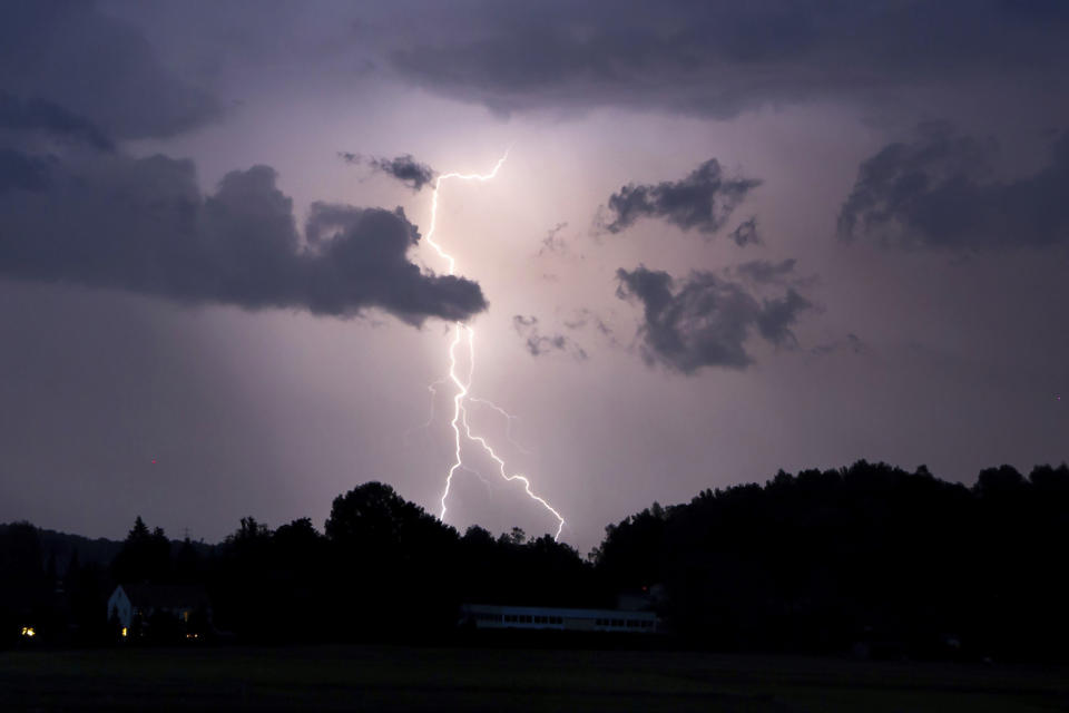 Lightning lights up the night sky In Neumarkt, Germany, Sunday, June 20, 2021. Heavy rains and thunderstorms have caused flooded cellars and streets as well as fallen trees and a variety of property damage in Central and Upper Franconia in the night to Monday. (Tobias Hartl/dpa via AP)