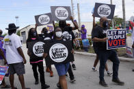 Supporters of restoring Florida felons' voting rights march to an early voting precinct, Saturday, Oct. 24, 2020, in Fort Lauderdale, Fla. The Florida Rights Restoration Coalition led marches to the polls in dozens of Florida counties. (AP Photo/Marta Lavandier)