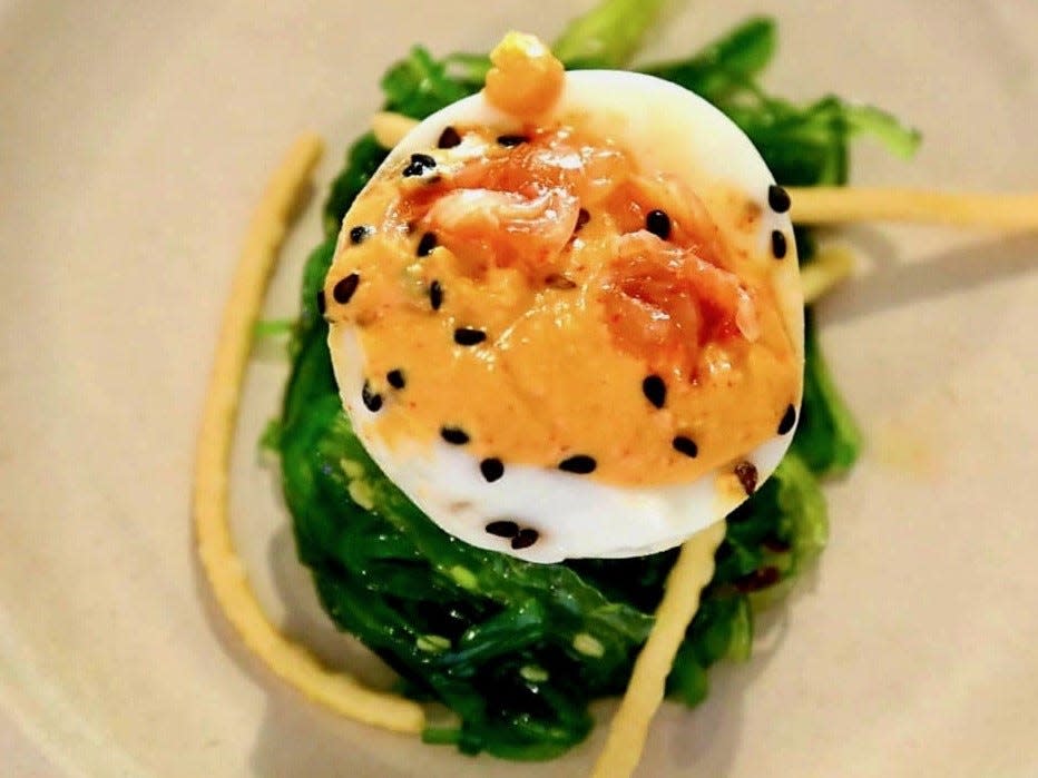 The menu at Salvador Deli at Walking Tree Brewery in Vero Beach features Kimchi deviled eggs, served atop a nest of kimchi seaweed salad and accompanied by crunchy noodles.